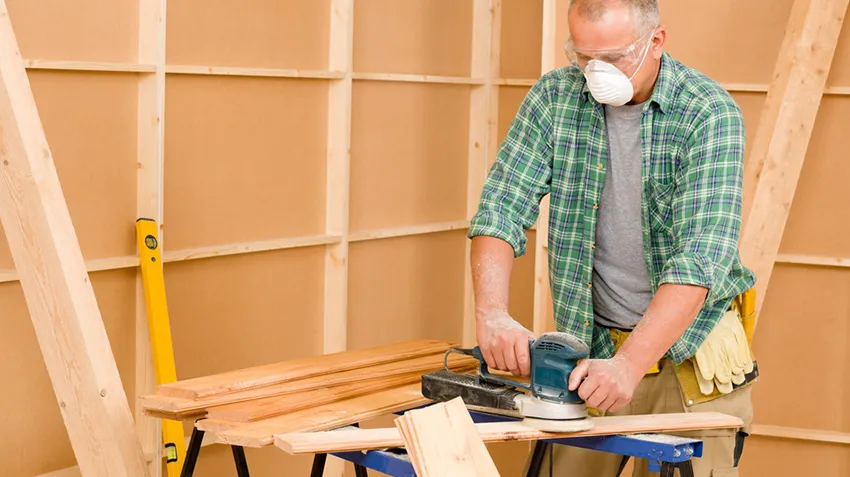 Handyman mature professional sanding wooden board diy new home renovation